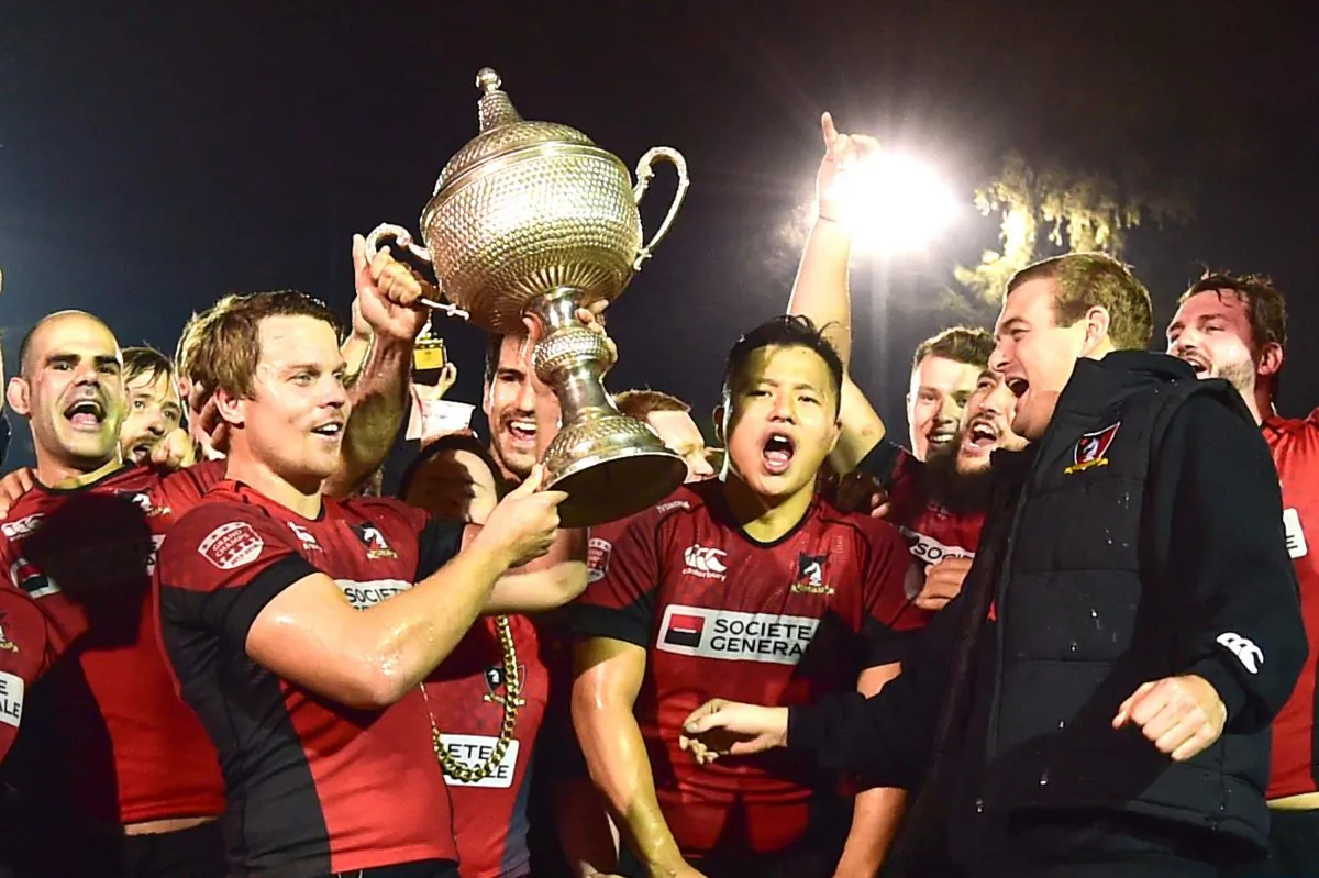 The light shines brightly on Societe Generale Valley as they celebrate winning their 5th consecutive Grand Champion trophy at King’s Park on Saturday March 11, 2017. (Bill Cox/Epoch Times)