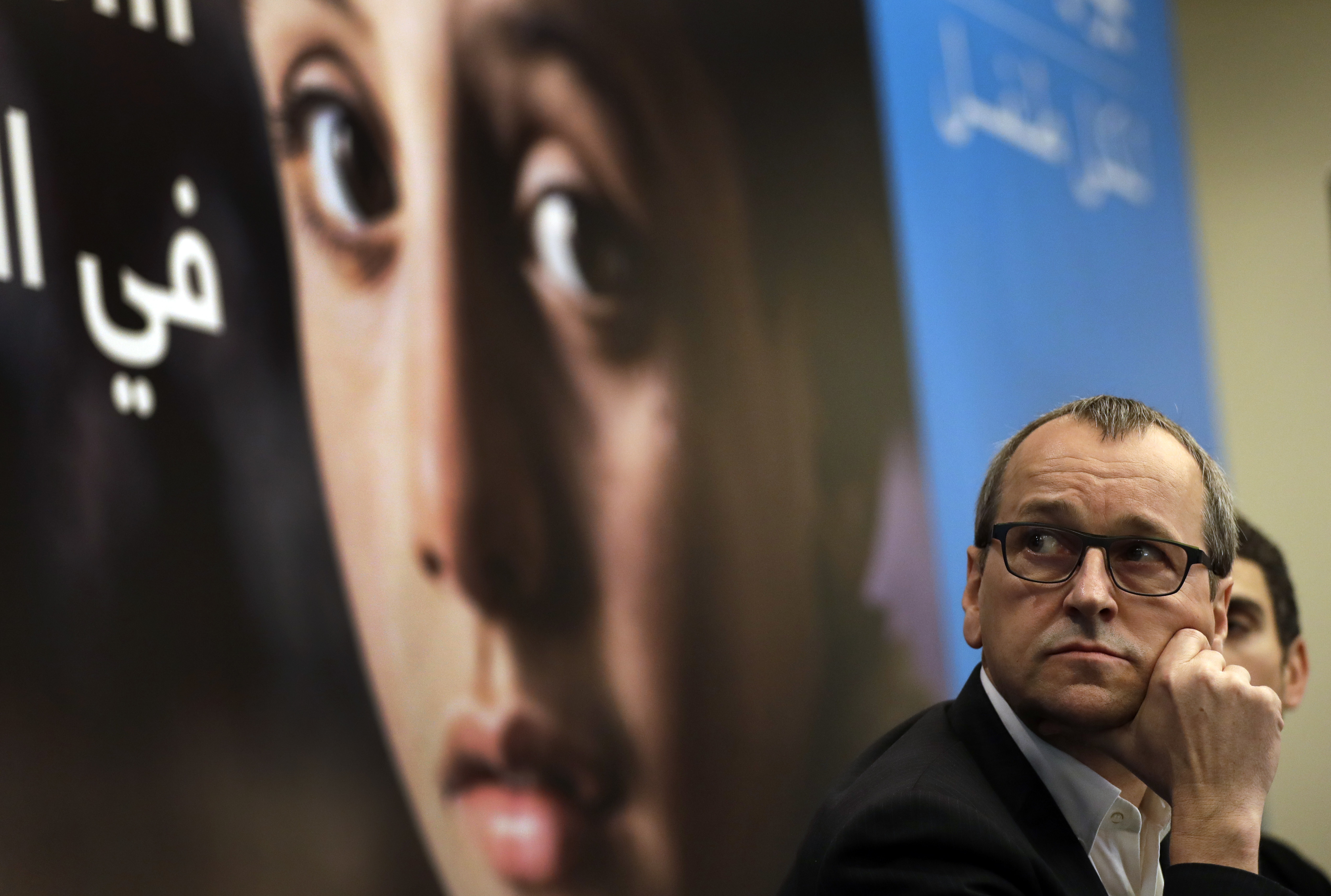 Geert Cappelaere, the U.N. Children's agency (UNICEF) regional director the Middle East and North Africa, watches a video clip on Syrian children during a press conference, in Beirut, Lebanon on March 15, 2017. (AP Photo/Hussein Malla)