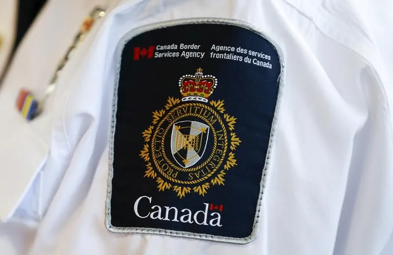 A Canada Border Services Agency (CBSA) logo is seen on a worker during a tour of the Infield Terminal at Toronto Pearson International Airport in Mississauga, Dec.r 8, 2015. (REUTERS/Mark Blinch)