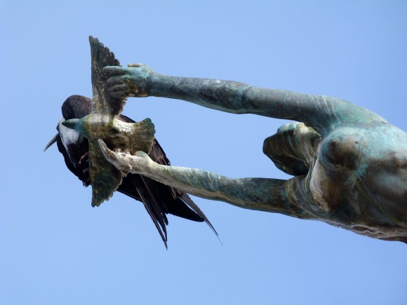"Los Milenios," with a live frigatebird perched on the dove of peace. (Barbara Angelakis)