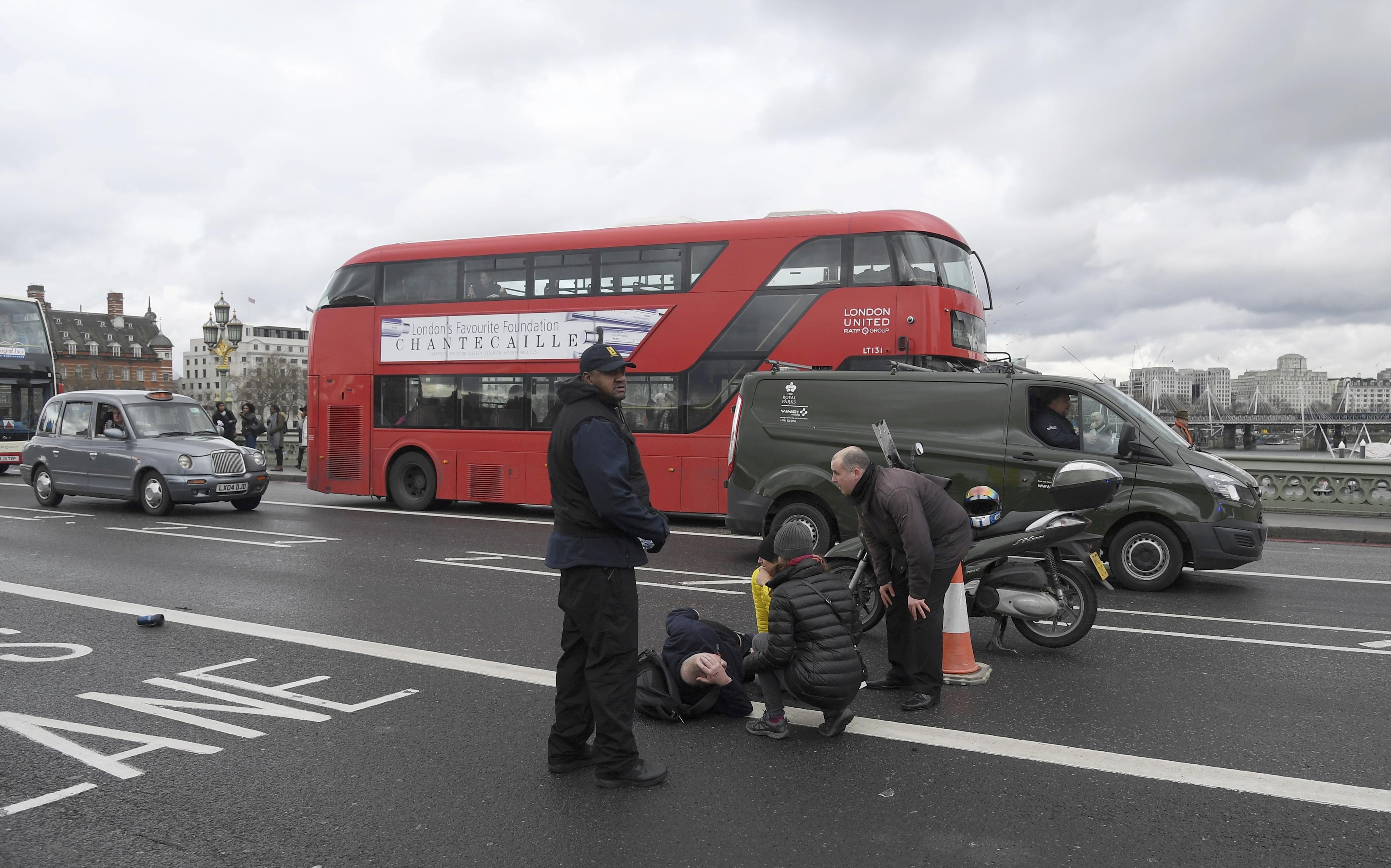 A man lies injured after a shooting incident on Westminster Bridge in London on March 22, 2017. (REUTERS/Toby Melville)