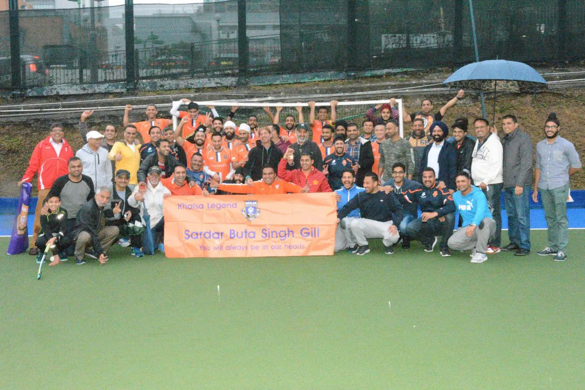 Khalsa players and supporters alike hold up a banner in memory of staunch supporter Sadar Buta Singh Gill who passed away at the start of the year. (Eddie So)
