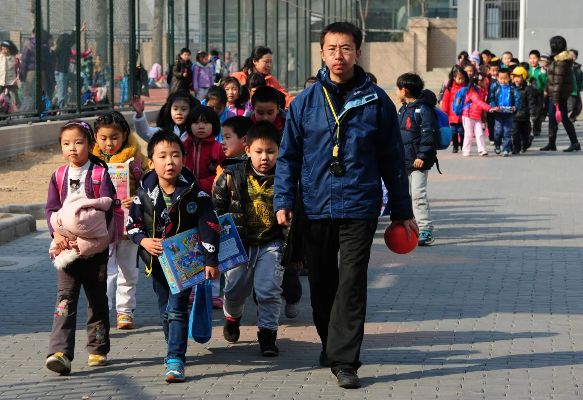 School children leave their elementary school in Beijing on March 13, 2012.
The plight of a Chinese father, posted online recently, resonated with an economically disenfranchised public.
(Mark Ralston/AFP/Getty Images)