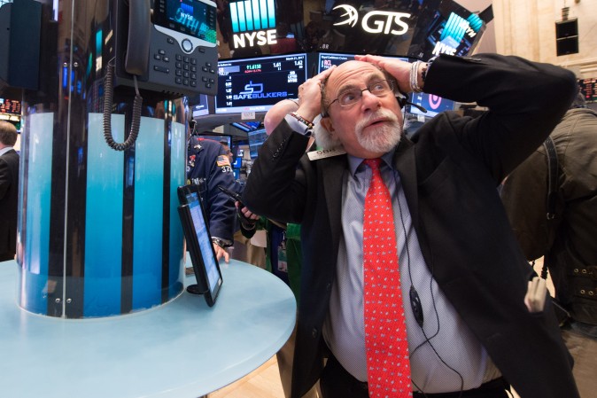 A trader works on the floor before the closing bell of the Dow Jones at the New York Stock Exchange on March 21, 2017. (BRYAN R. SMITH/AFP/Getty Images)