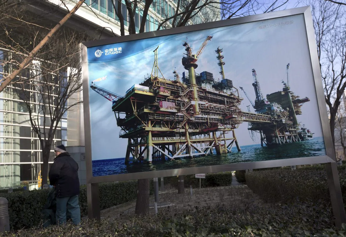 A photo of the state-owned China National Offshore Oil Corp. (CNOOC) platform outside its headquarters in Beijing, China. After Canada approved CNOOC’s takeover of Canadian oil and gas producer Nexen, it vowed to reject any future foreign takeovers in the oil sands sector by state-owned companies. (AP Photo/Andy Wong)