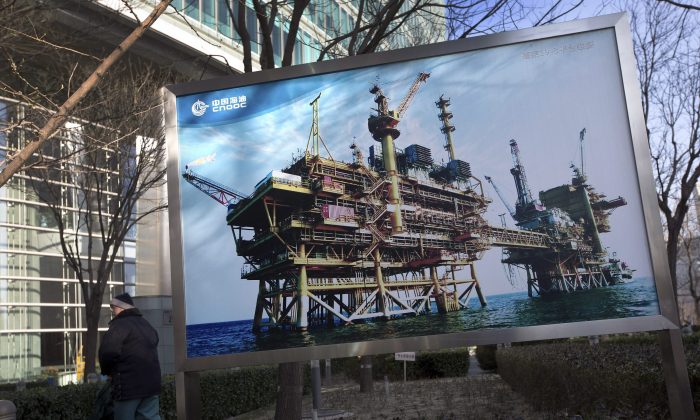 A photo of the state-owned China National Offshore Oil Corp. (CNOOC) platform outside its headquarters in Beijing, China. After Canada approved CNOOC’s takeover of Canadian oil and gas producer Nexen, it vowed to reject any future foreign takeovers in the oil sands sector by state-owned companies. (AP Photo/Andy Wong)