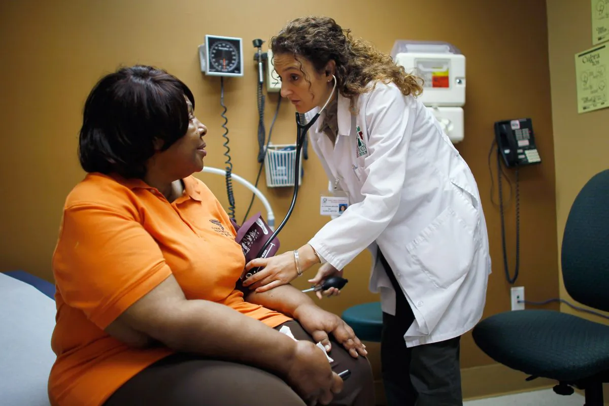 A woman is examined by a doctor during a routine checkup at the Jessie Trice Center for Community Health Center in Miami, Fla., in 2012. (Joe Raedle/Getty Images)