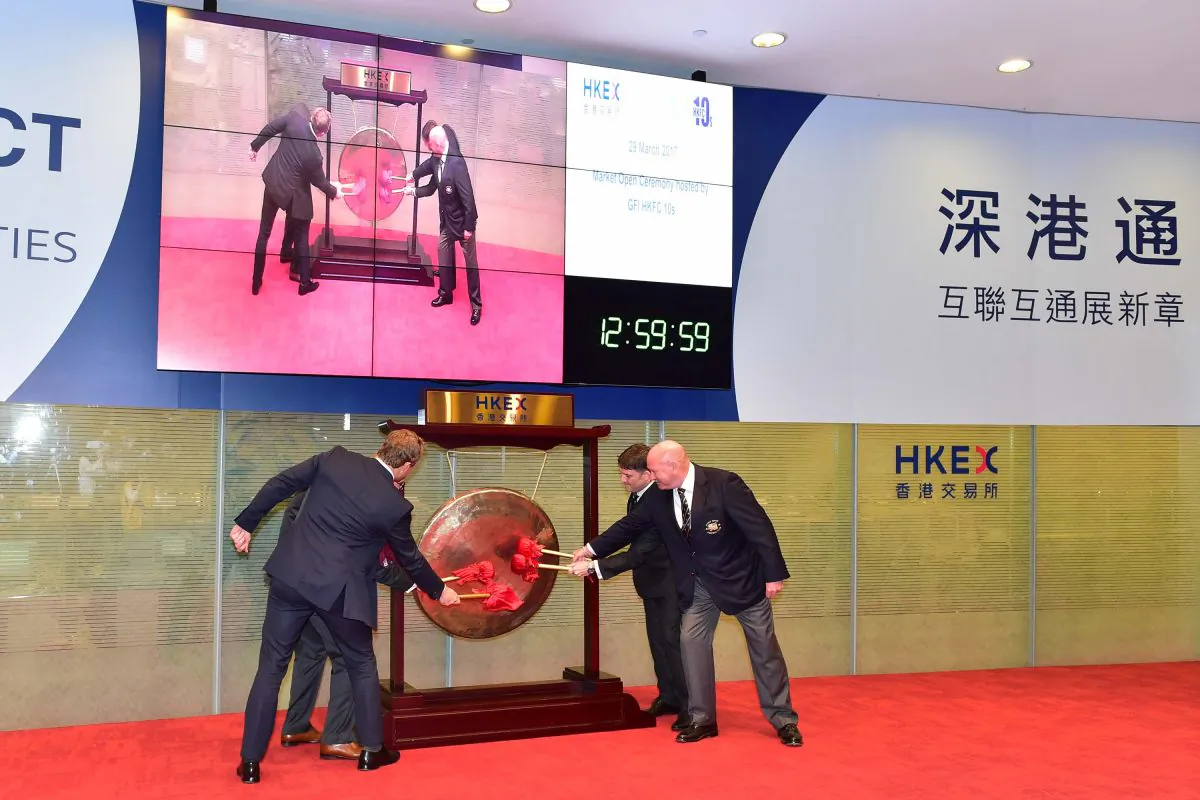 Banging the Gong to launch the GFI HKFC Rugby 10;s tournament and to open afternoon trading at the Hong Kong Stock Exchange on Wednesday March 29, 2017 are (L-R) special guest Josh Lewsey, Scott Tathem of title sponsors GFI Asia Pacific,  David Nazer Chairman of Organising Committee and Vern Reid Chairman of HKRU. (Bill Cox/Epoch Times)