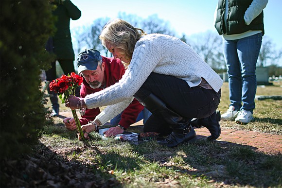 Kim Sullivan and Mark Comparone leave flowers at the grave of their son Benjamin, who died from a heroin overdose at age 27 in 2015, in Plantsville, Conn., on March 7, 2016. (John Moore/Getty Images)