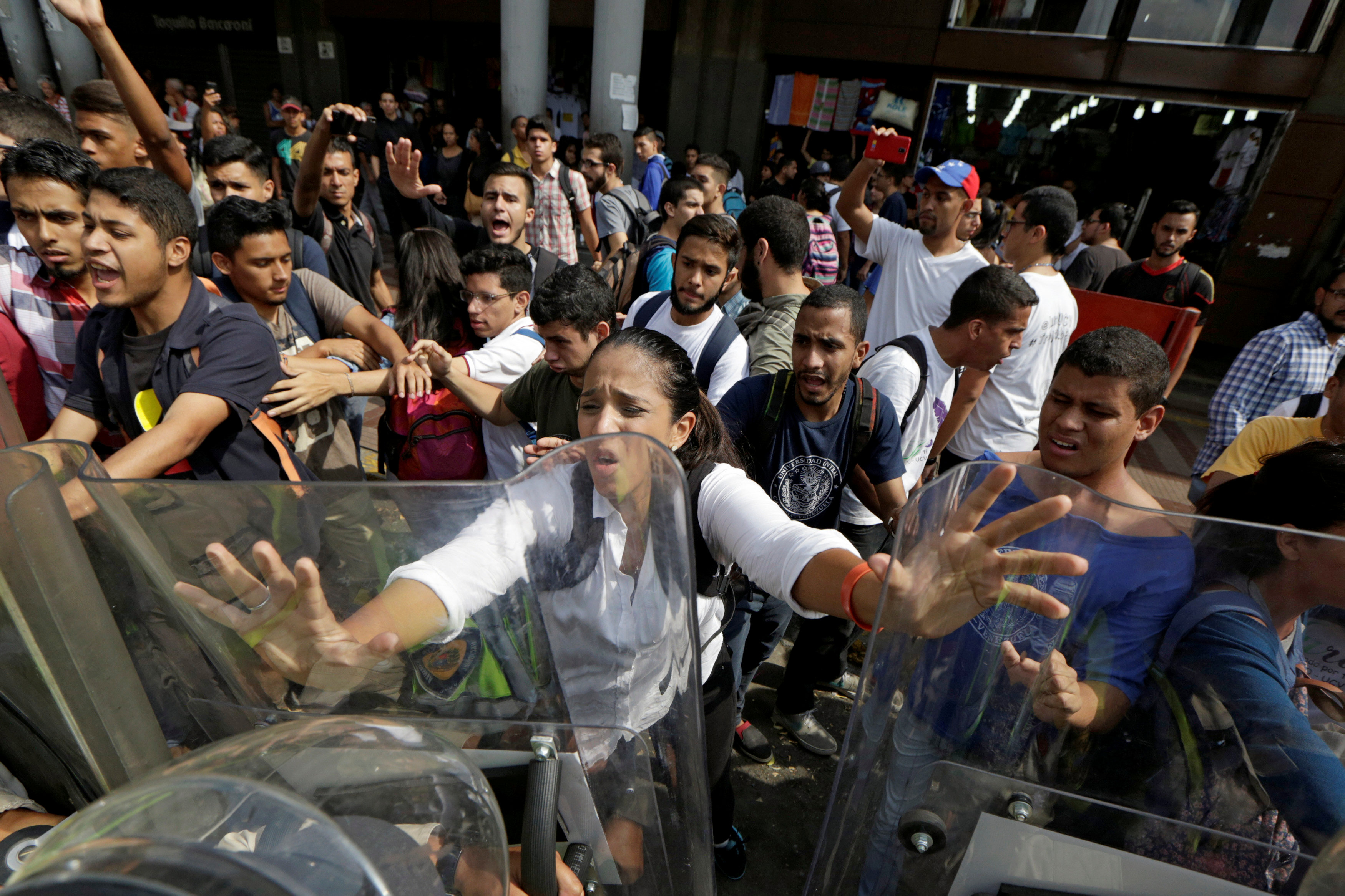 Opposition supporters clash with riot police in front of a courthouse in Caracas, Venezuela on March 31, 2017. (REUTERS/Marco Bello)