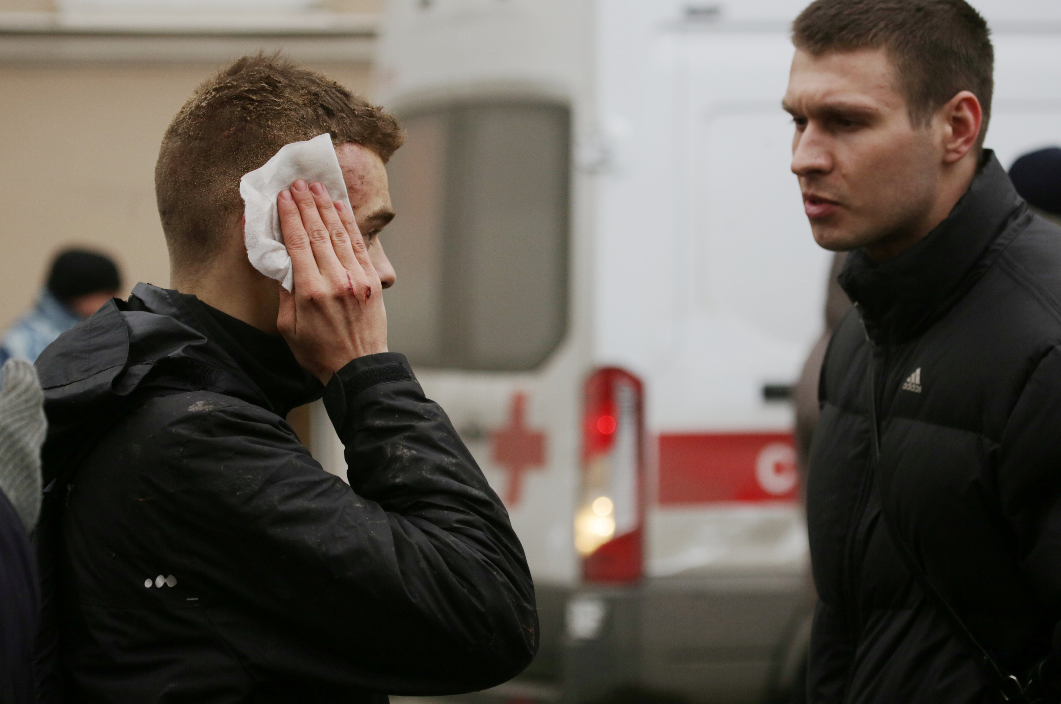 An injured person stands outside Sennaya Ploshchad metro station, following explosions in two train carriages at metro stations in St. Petersburg. (REUTERS/Anton Vaganov)