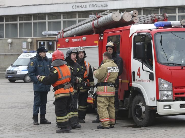 Members of the Emergency services stand outside Sennaya Ploshchad metro station in St. Petersburg, Russia on April 3, 2017. (REUTERS/Igor Russak)