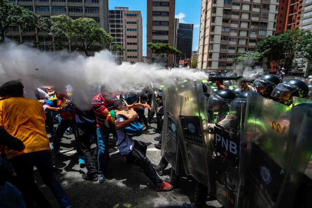 Venezuela's opposition activists clash with riot police agents during a protest against Nicolas Maduro's government in Caracas on April 4, 2017.(JUAN BARRETO/AFP/Getty Images)
