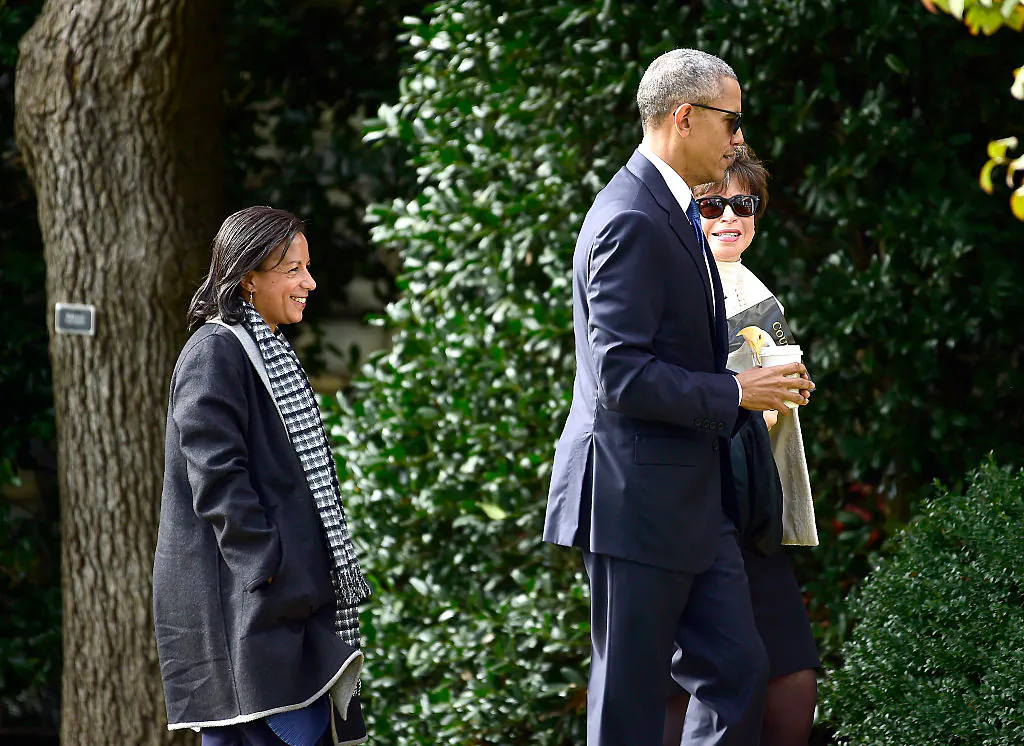 Former President Barack Obama returns to the White House with National Security Advisor Susan Rice (L) and Senior Advisor and Assistant to the President, White House Valerie Jarrett (R) after making remarks at Arlington National Cemetery in Arlington, Virginia on Nov.11, 2016. (Ron Sachs-Pool/Getty Images)