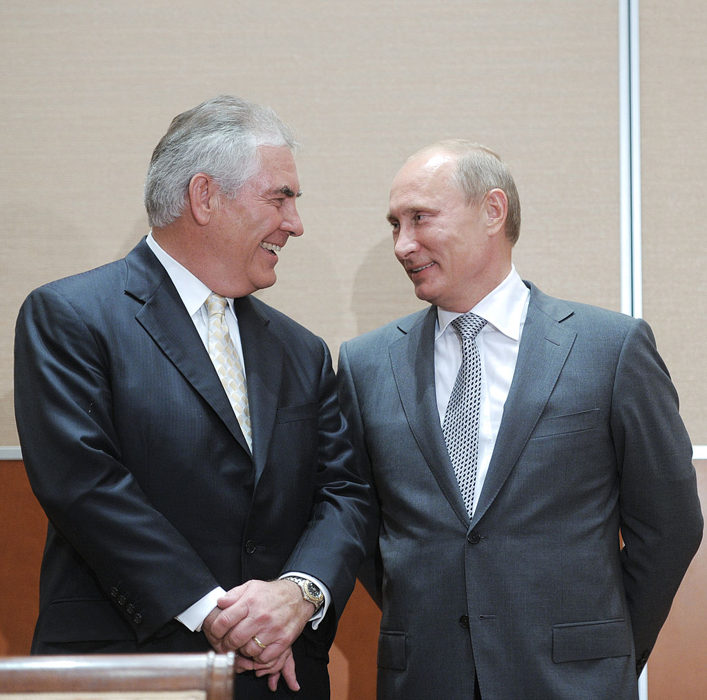 Russia's Prime Minister Vladimir Putin (L) speaks with ExxonMobil President and Chief Executive Officer Rex Tillerson during the signing of a Rosneft-ExxonMobil strategic partnership agreement in Sochi on August 30, 2011. Russia's oil champion Rosneft and US ExxonMobil clinched a global deal worth up to half-a-trillion dollars that will see the US supermajor take BP's place in pioneering Arctic exploration work. AFP PHOTO / RIA NOVOSTI / POOL / ALEXEY DRUZHININ (Photo credit should read ALEXEY DRUZHININ/AFP/Getty Images)