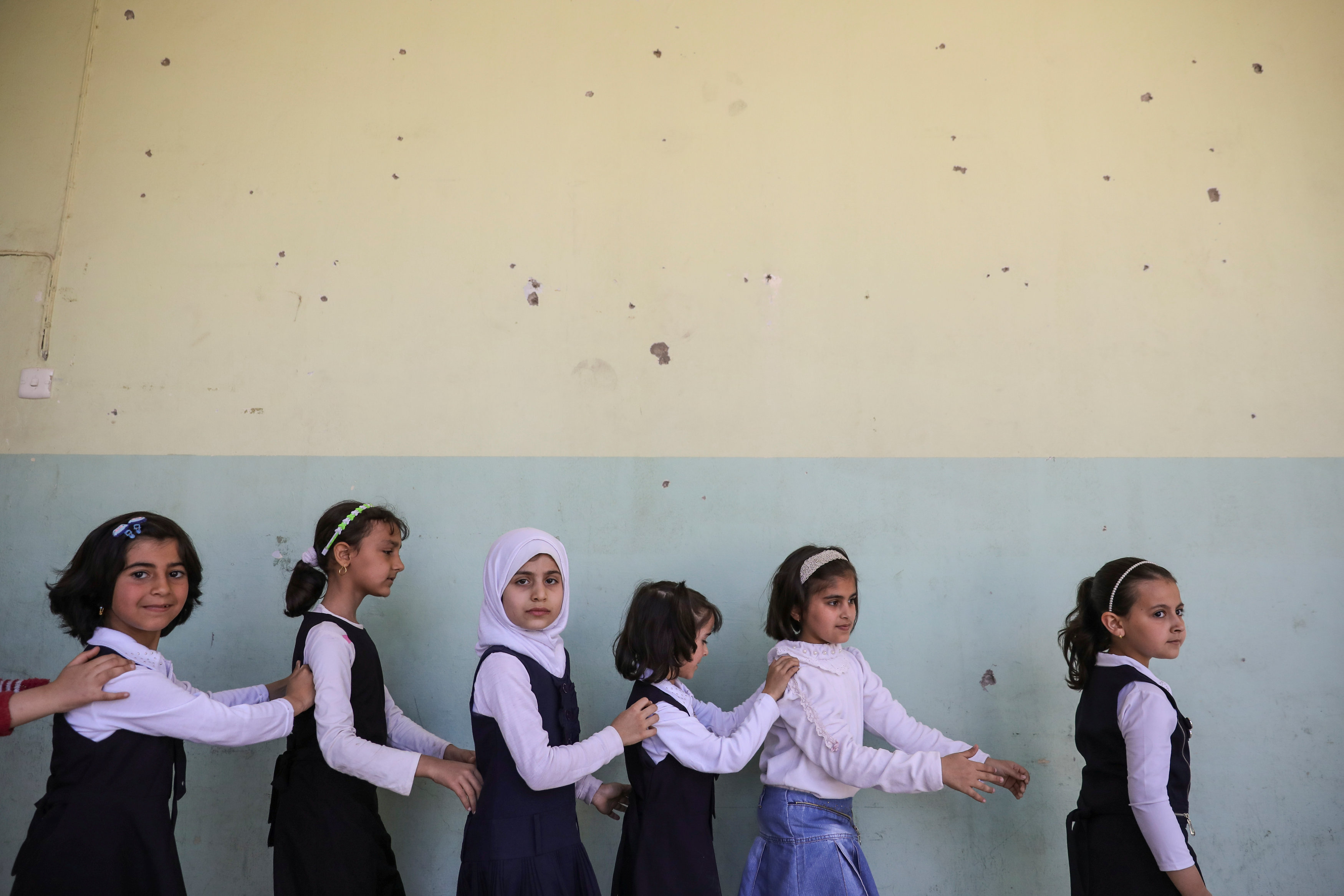 Pupils walk out from their classroom at an elementary school in eastern Mosul, Iraq on April 17, 2017. (REUTERS/Marko Djurica)