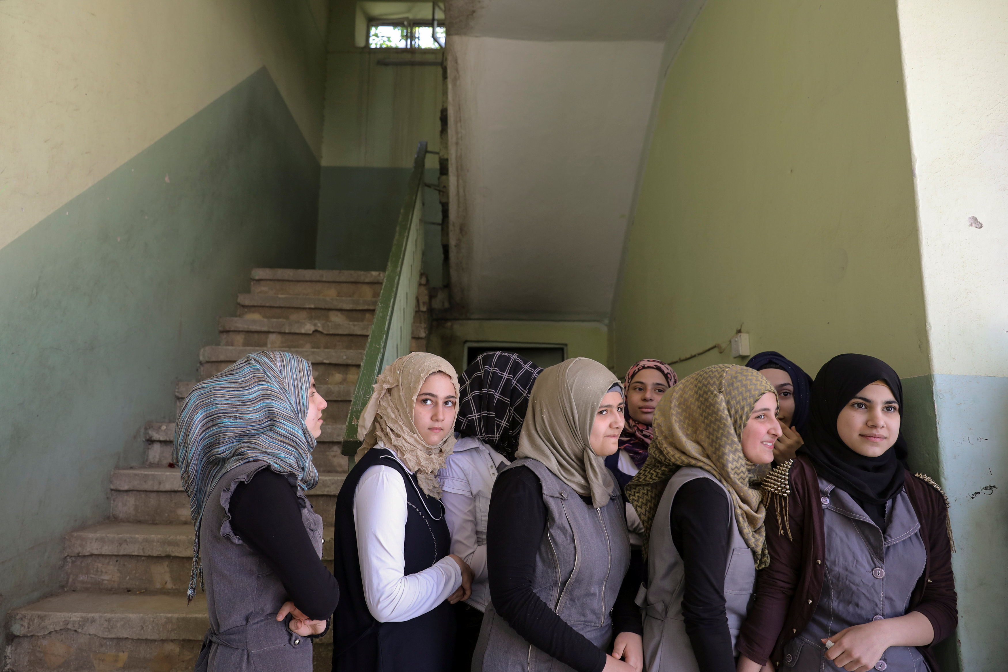 Pupils stand outside their classroom at an elementary school in eastern Mosul, Iraq on April 17, 2017. (REUTERS/Marko Djurica)