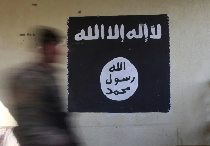 File Photo: A member of the Iraqi rapid response forces walks past a wall painted with the black flag commonly used by ISIS terrorists, at a hospital damaged by clashes during a battle between Iraqi forces and ISIS terrorists in the Wahda district of eastern Mosul, Iraq on Jan. 8, 2017. (Reuters/Alaa Al-Marjani)