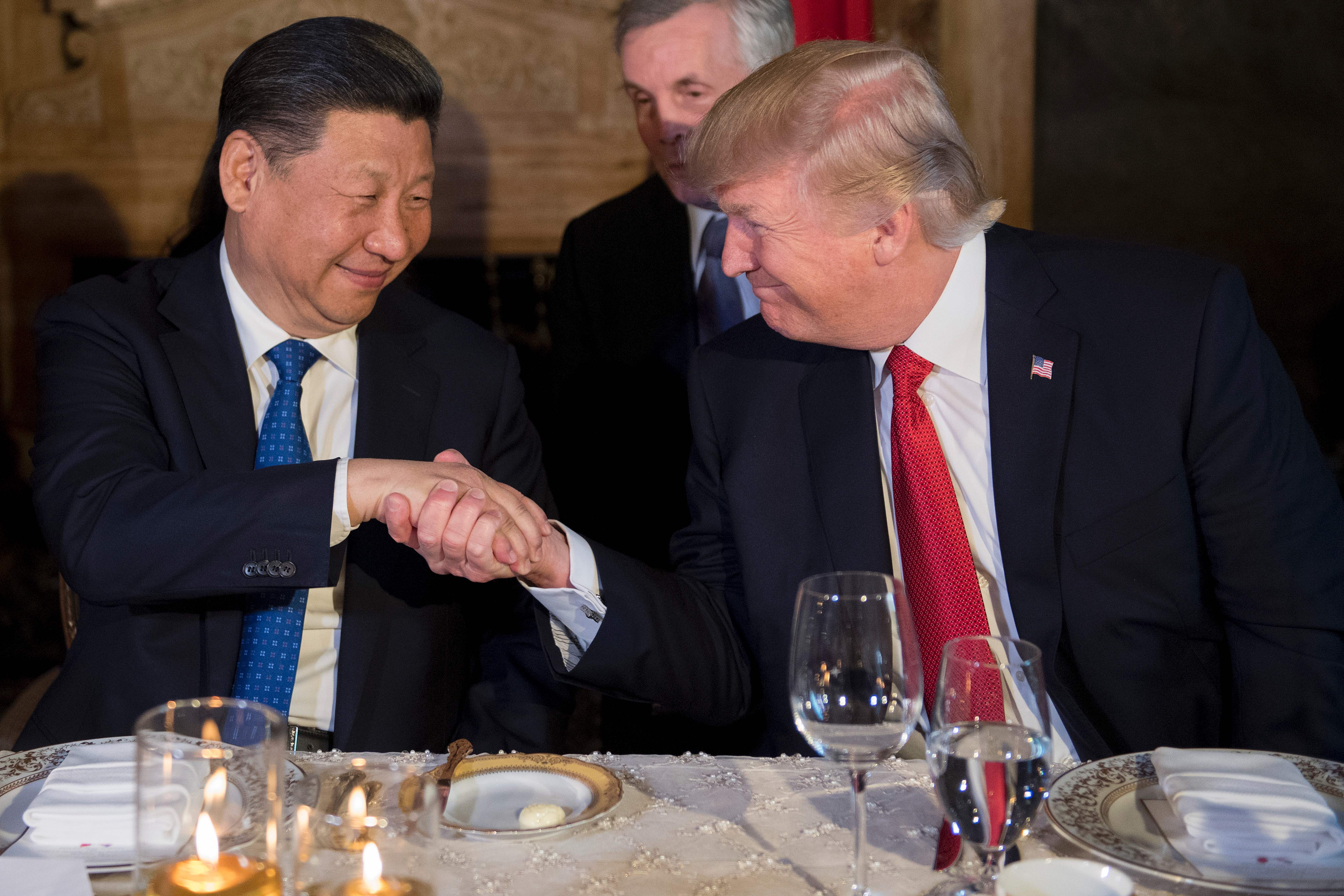 (R-L) President Donald Trump and Chinese leader Xi Jinping shake hands during dinner at the Mar-a-Lago estate in West Palm Beach, Florida, on April 6, 2017. (JIM WATSON/AFP/Getty Images)