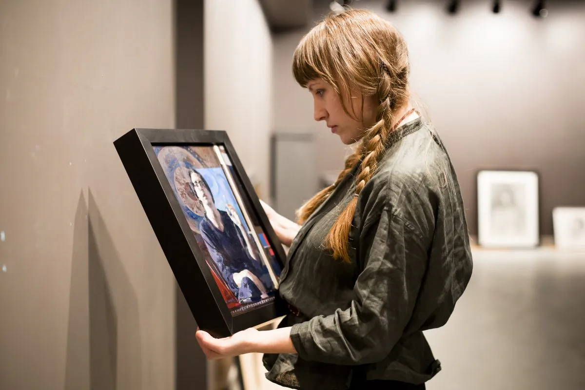 Colleen Barry, artist and curator, prepares the "Self Portrait" exhibition at Eleventh Street Arts gallery in Long Island City, New York on April 19, 2017. (Samira Bouaou/The Epoch Times)