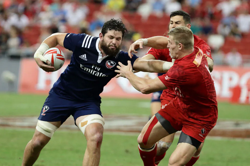 Danny Barrett of USA fends off a challenge from John Moonlight of Canada during the Cup Final 2017 Singapore Sevens match between USA and Canada at National Stadium on April 16, 2017 in Singapore. (Suhaimi Abdullah/Getty Images)