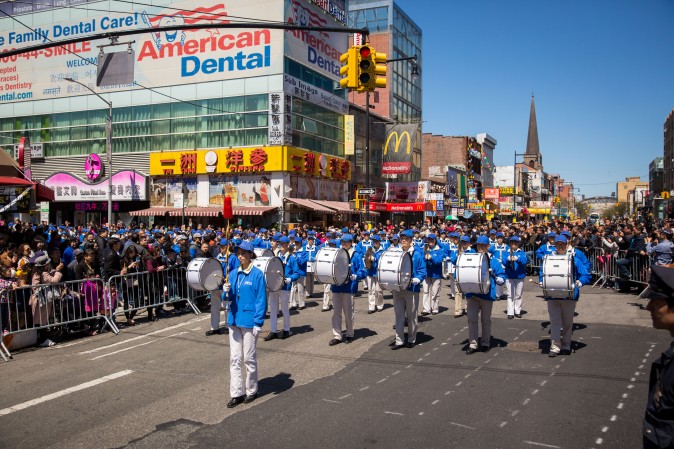Falun Gong practitioners march in a parade in Flushing, New York, on April 23, 2017, to commemorate the 18th anniversary of the April 25th peaceful appeal of 10,000 Falun Gong practitioners in Beijing. (Benjamin Chasteen/The Epoch Times)