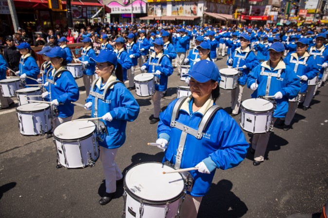 Falun Gong practitioners march in a parade in Flushing, New York, on April 23, 2017, to commemorate the 18th anniversary of the April 25th peaceful appeal of 10,000 Falun Gong practitioners in Beijing. (Benjamin Chasteen/The Epoch Times)