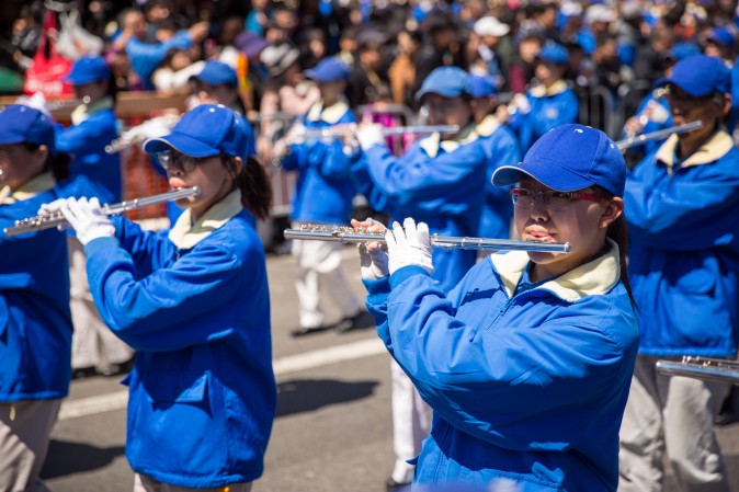 Falun Gong practitioners march in a parade in Flushing, New York, on April 23, 2017, to commemorate the 18th anniversary of the April 25th peaceful appeal of 10,000 Falun Gong practitioners in Beijing. (Benjamin Chasteen/The Epoch Times)