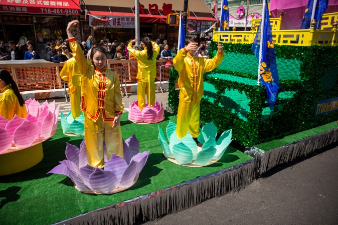Falun Gong practitioners march in a parade in Flushing, New York, on April 23, 2017, to commemorate the 18th anniversary of the April 25th peaceful appeal of 10,000 Falun Gong practitioners in Beijing. (Benjamin Chasteen/The Epoch Times)