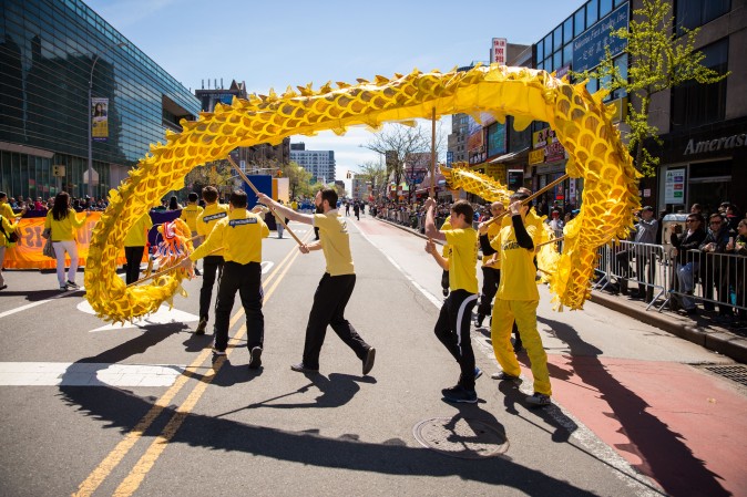 Falun Gong practitioners march in a parade in Flushing, New York, on April 23, 2017, to commemorate the 18th anniversary of the April 25th peaceful appeal of 10,000 Falun Gong practitioners in Beijing. (Benjamin Chasteen/The Epoch Times)