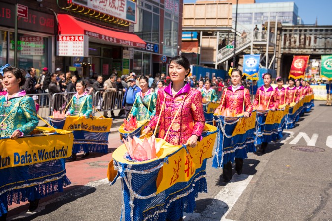 Falun Gong practitioners march in a parade in Flushing, New York, on April 23, 2017, to commemorate the 18th anniversary of the April 25th peaceful appeal of 10,000 Falun Gong practitioners in Beijing. (Benjamin Chasteen/The Epoch Times)