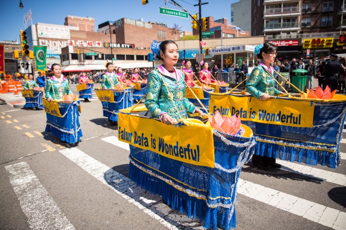 Falun Gong practitioners march in a parade in Flushing, New York, on April 23, 2017, to commemorate the 18th anniversary of the April 25th peaceful appeal of 10,000 Falun Gong practitioners in Beijing. (Benjamin Chasteen/The Epoch Times)