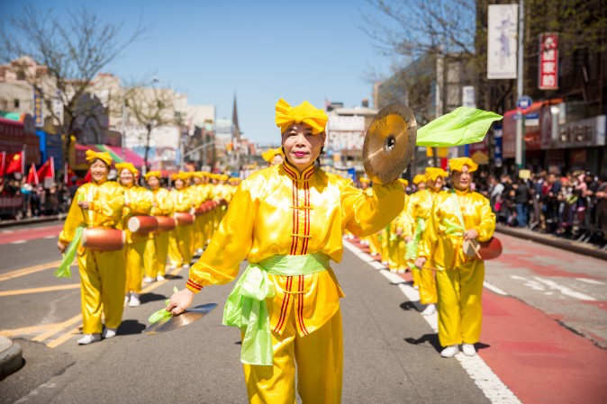 Falun Gong practitioners march in a parade in Flushing, New York, on April 23, 2017, to commemorate the 18th anniversary of the April 25th peaceful appeal of 10,000 Falun Gong practitioners in Beijing. (Benjamin Chasteen/The Epoch Times)