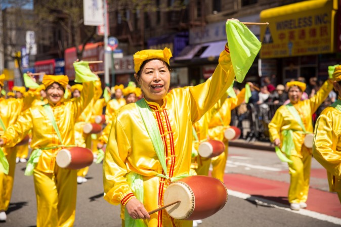 Falun Gong practitioners march in a parade in Flushing, New York, on April 23, 2017, to commemorate the 18th anniversary of the April 25th peaceful appeal of 10,000 Falun Gong practitioners in Beijing. (Benjamin Chasteen/The Epoch Times)