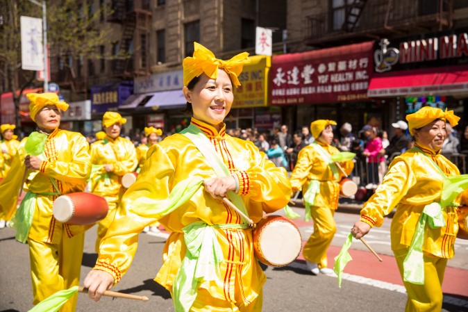 Falun Gong practitioners march in a parade in Flushing, New York, on April 23, 2017, to commemorate the 18th anniversary of the April 25th peaceful appeal of 10,000 Falun Gong practitioners in Beijing. (Benjamin Chasteen/The Epoch Times)