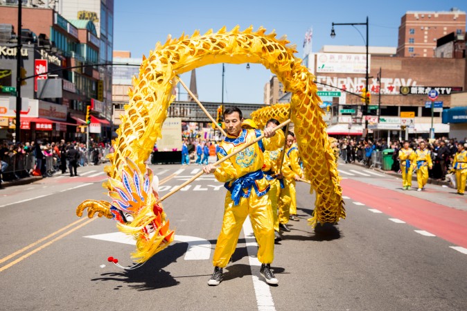 Falun Gong practitioners march in a parade in Flushing, New York, on April 23, 2017, to commemorate the 18th anniversary of the April 25th peaceful appeal of 10,000 Falun Gong practitioners in Beijing. (Benjamin Chasteen/The Epoch Times)
