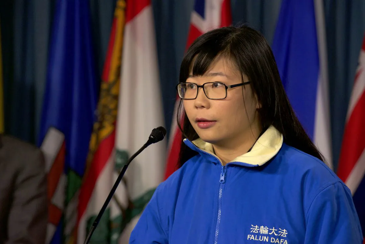 Hope Chen speaks to reporters on Parliament Hill on Dec. 9, 2015. The 22-year-old has been trying to draw attention to the plight of her father who was imprisoned in China for suing former Chinese leader Jiang Zemin. Chen was threatened by a Chinese agent for discussing his detention in the media. (Matthew Little/Epoch Times)