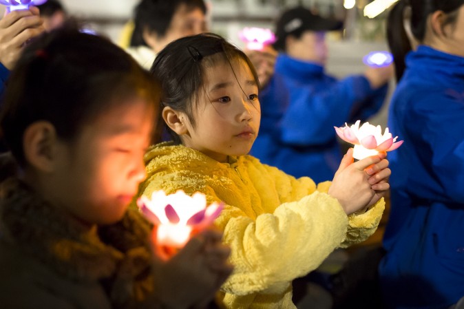 Young Falun Gong practitioner attend a candlelight vigil near the Chinese Consulate in New York on April 23, 2017. (Samira Bouaou/The Epoch Times) 