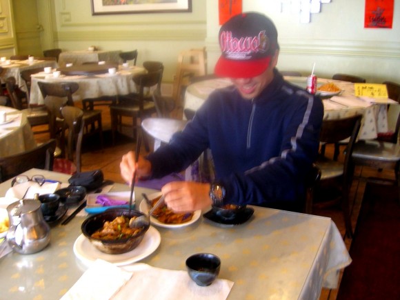 Eugene Wu, owner of Brother Wu's restaurant, digs into three-cup chicken, a recipe from his grandmother in Taiwan. (Susan Korah)