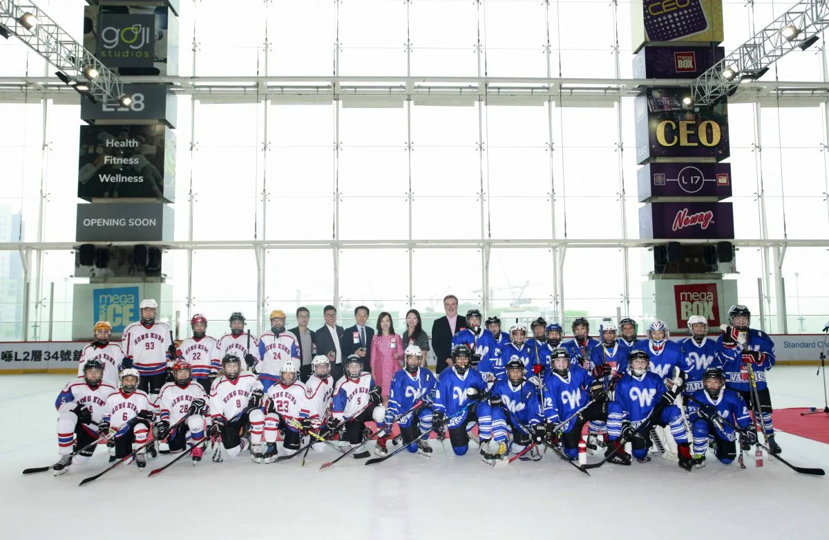 (L-R) HK Selects White (white)and Bangkok Warriors (blue) line up for a group photo with all puck drop ceremony officiating guests before coming head-to-head after the ceremony. (Mega Ice)