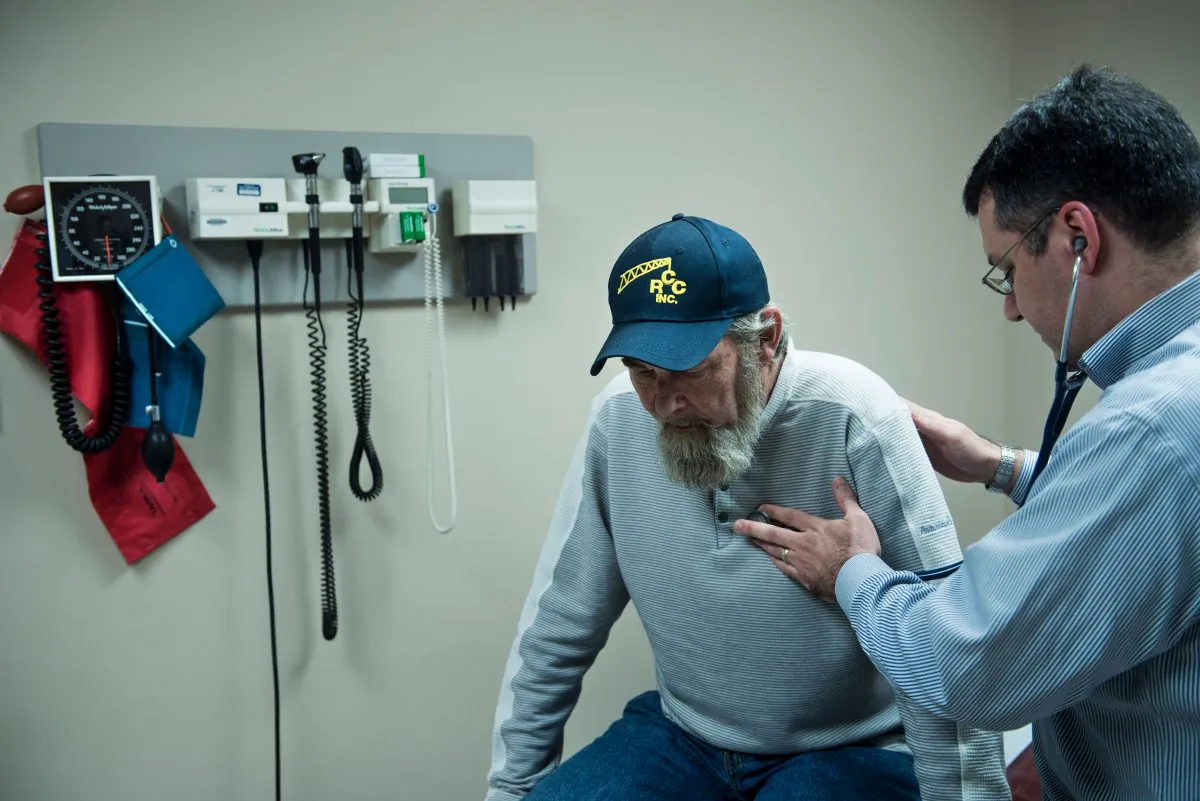 A lung cancer patient is seen being examined by a doctor in West Virginia in a file photo.    (Brendan Smialowski/AFP/Getty Images)