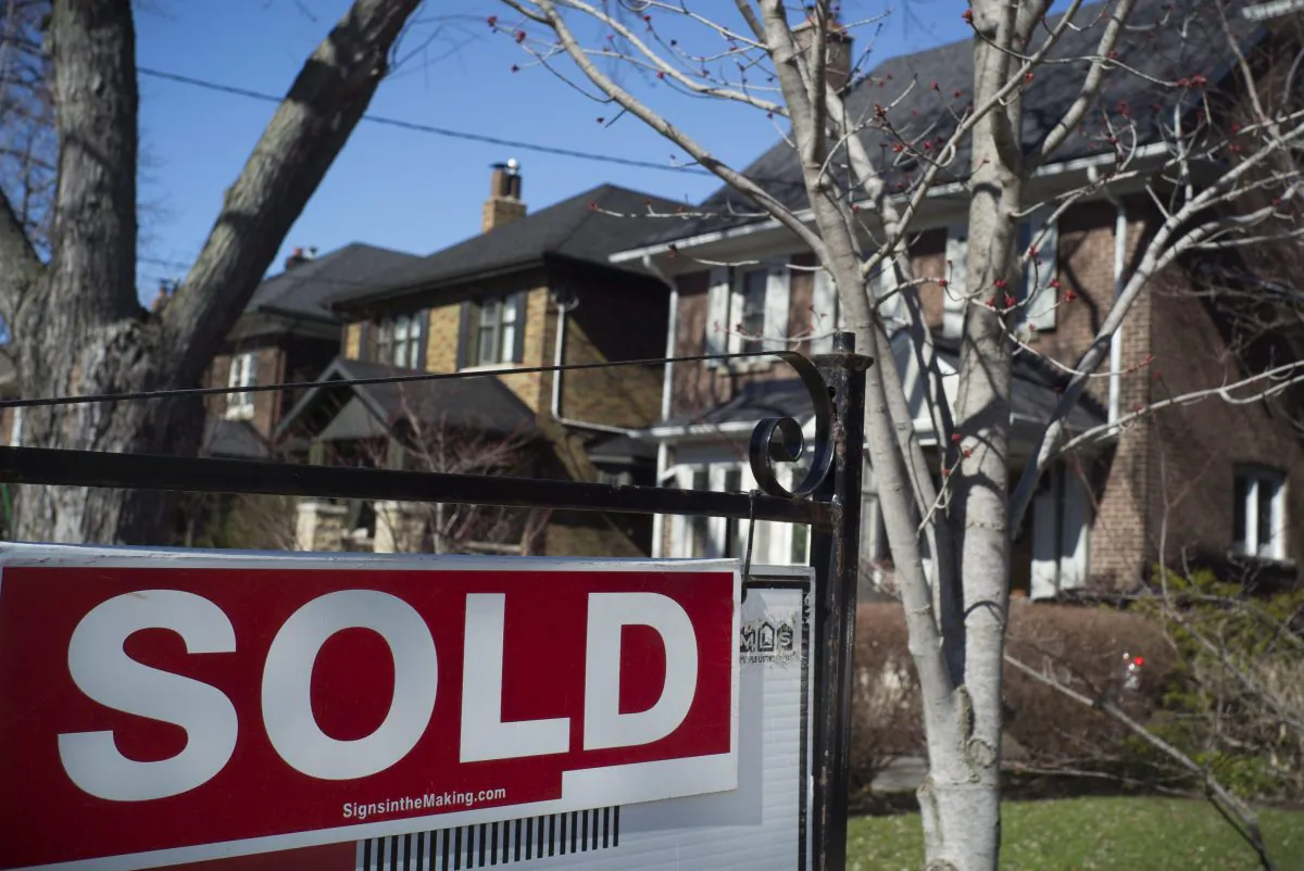 A sold sign is seen in front of a west-end Toronto home on April 9, 2017. Toronto’s overheating housing market should not be an impediment to kick-starting a private-label mortgage-backed securities market, according to two mortgage industry experts. (The Canadian Press/Graeme Roy)