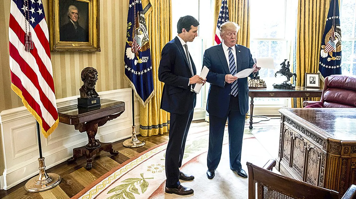 President Donald Trump speaks to son-in-law and White House senior adviser Jared Kushner in the Oval Office of the White House on April 21. (AP PHOTO/ANDREW HARNIK)