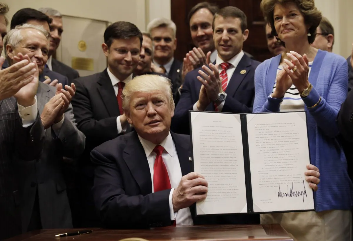 President Donald Trump displays an Executive Order on "Offshore Energy Strategy" at the White House in Washington on April 28, 2017. (REUTERS/Kevin Lamarque)