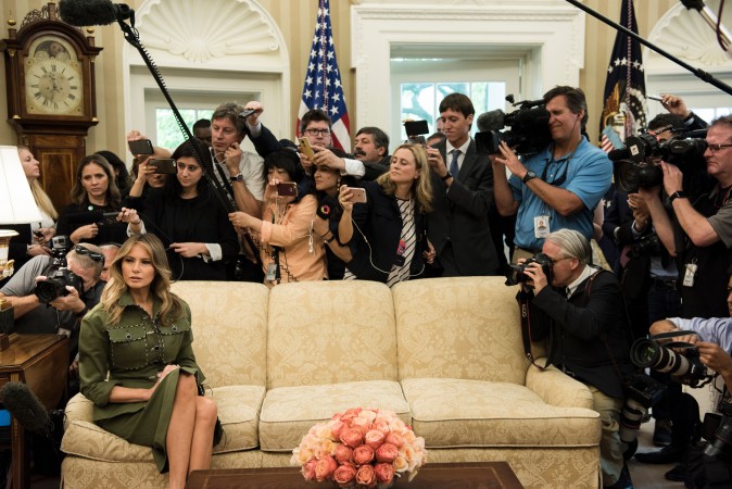 First Lady Melania Trump listens while President Donald Trump speaks to the press before a meeting with Argentina's President Mauricio Macri in the Oval Office of the White House on April 27. (BRENDAN SMIALOWSKI/AFP/Getty Images)