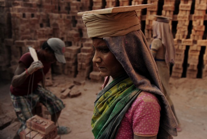 An laborer works at a brick factory near Allahabad, India, on April 30, 2017, on the eve of International Labour Day. (SANJAY KANOJIA/AFP/Getty Images)