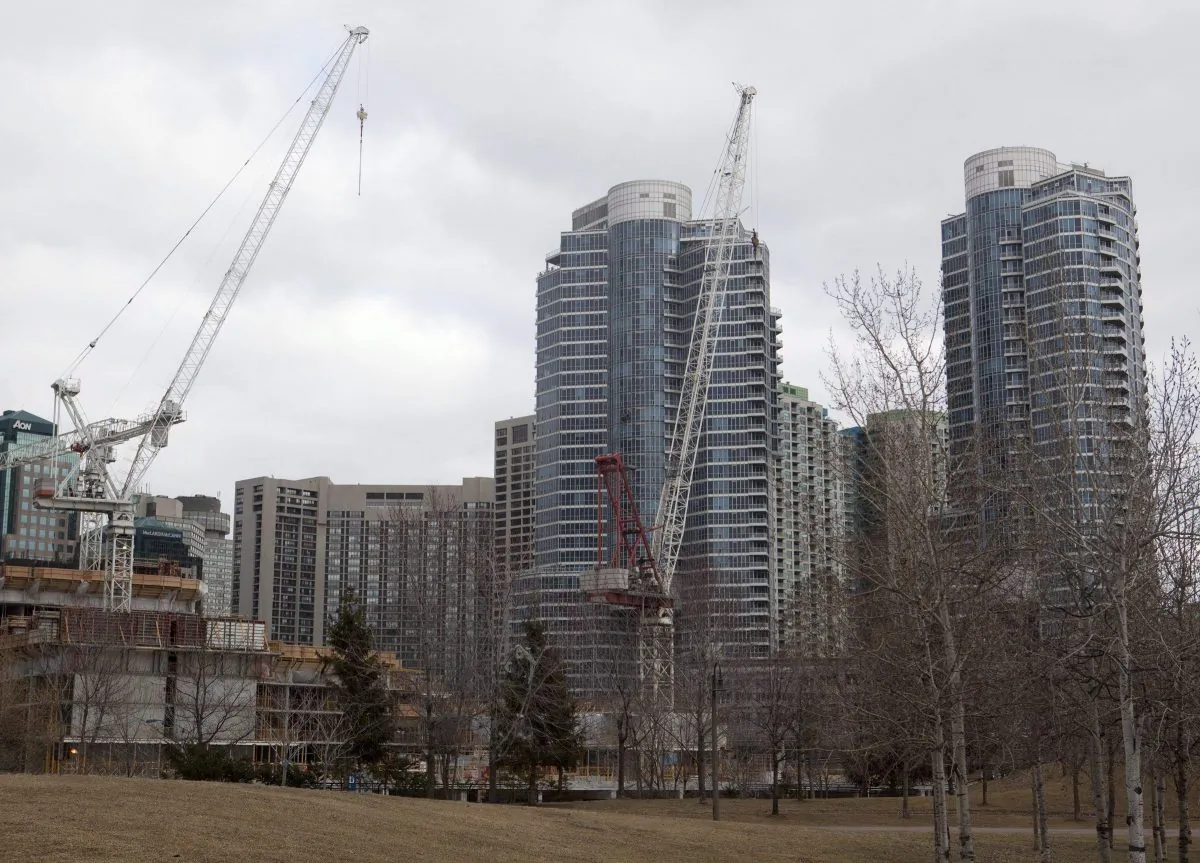 Construction cranes stand in front of condominiums in downtown Toronto in a file photo. (The Canadian Press/Pawel Dwulit)