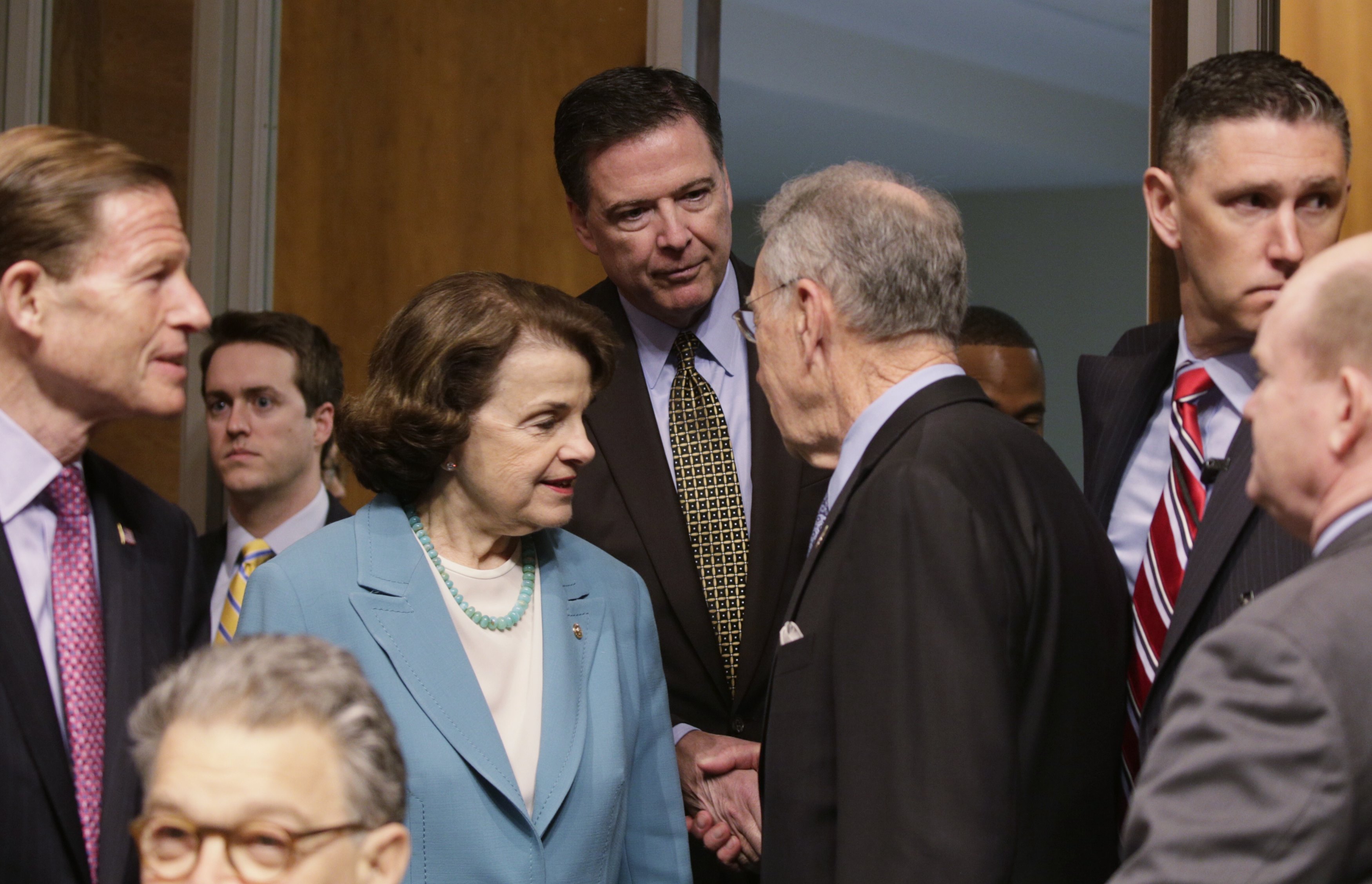 FBI Director James Comey (C) is greeted by ranking member Sen. Dianne Feinstein (D-CA) (3rdL) and Committee Chairman Chuck Grassley (R-IA) (3rdR) as he arrives to testify before a Senate Judiciary Committee hearing on "Oversight of the Federal Bureau of Investigation" on Capitol Hill in Washington on May 3, 2017. (REUTERS/Kevin Lamarque)