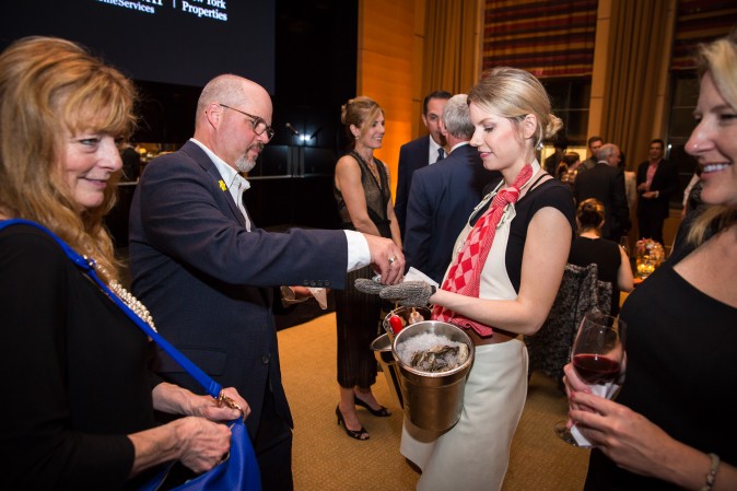 Guests and real estate agents celebrate the opening of Berkshire Hathaway HomeServices New York Properties hosted at the Four Seasons hotel in Manhattan on April 26, 2017. (Benjamin Chasteen/The Epoch Times)