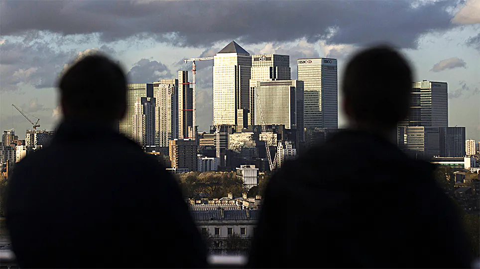 Late afternoon sunshine falls on the financial district in East London in 2014. Some areas of East London have seen a rash of gang related acid attacks carried out by men against other men. (ANDREW COWIE/AFP/GETTY IMAGES)